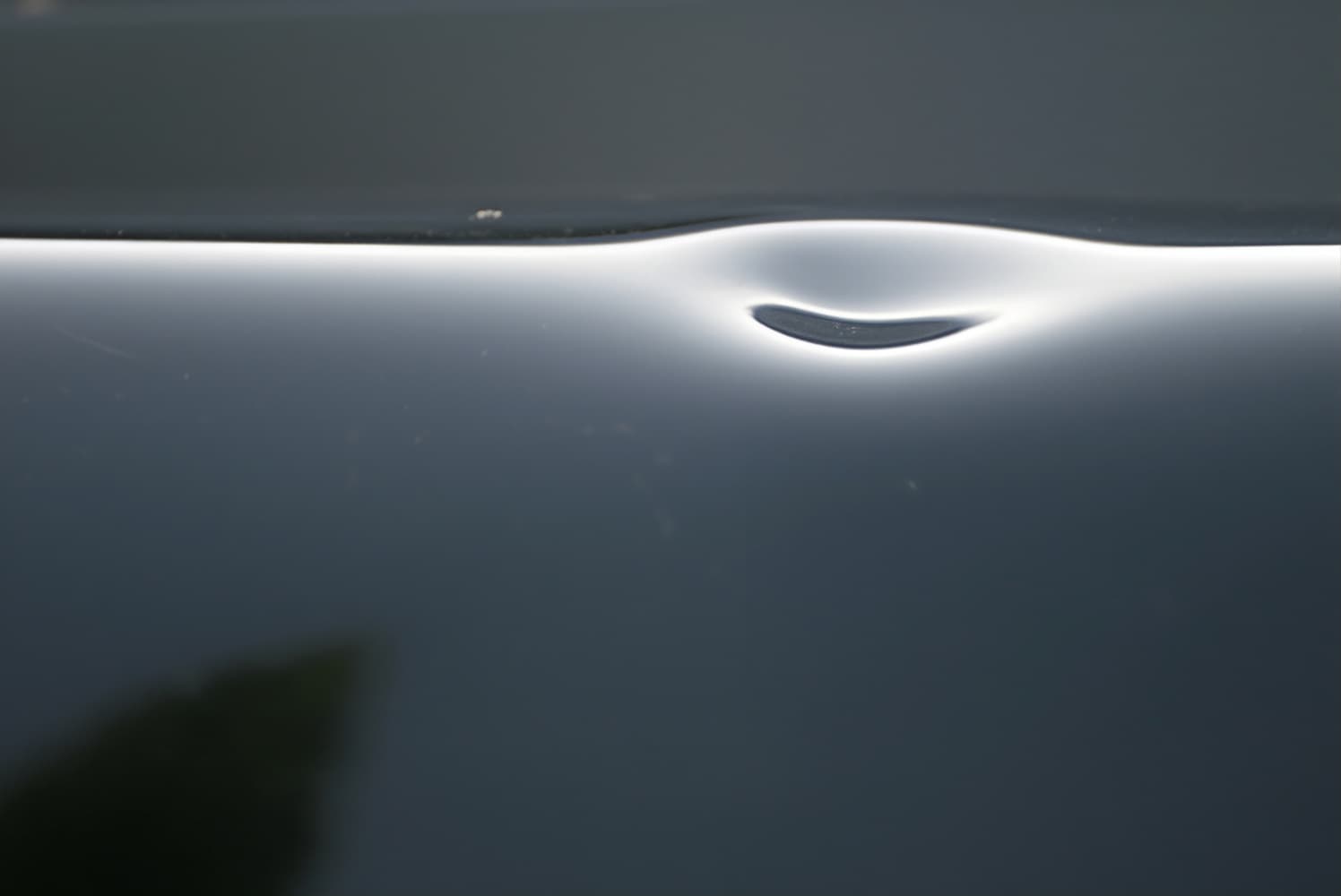 Car hood with dent