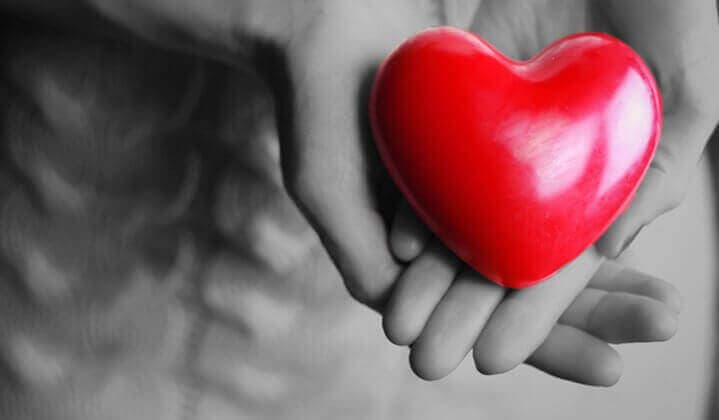 Hands holding a red heart